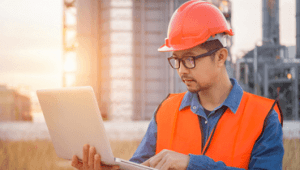 Construction worker holding laptop
